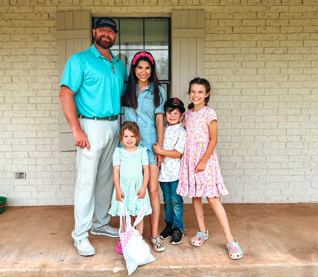 Group Picture of the Hass Family wearing tones of pink and blue.